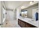 Bright bathroom with double sinks, large mirror, and enclosed shower with white fixtures at 7888 E 139Th Pl, Brighton, CO 80602