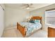 Comfortable bedroom with warm lighting and wooden bed frame with a view to the neighborhood at 7888 E 139Th Pl, Brighton, CO 80602