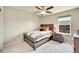 Cozy bedroom with a comfortable bed, wooden furnishings, and a large window at 7888 E 139Th Pl, Brighton, CO 80602