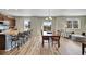Open-concept dining area with bar seating, a dining table, and a cozy sitting area, perfect for Gathering gatherings at 7888 E 139Th Pl, Brighton, CO 80602