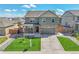 Inviting home with a covered front porch, green lawn, and an attached two-car garage at 7888 E 139Th Pl, Brighton, CO 80602