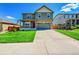 Charming two-story home with a covered porch, stone accents, and well-maintained landscaping at 7888 E 139Th Pl, Brighton, CO 80602