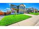 Beautiful two-story home featuring a covered porch, green lawn, and a two-car garage at 7888 E 139Th Pl, Brighton, CO 80602
