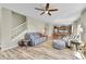 Cozy living room with wood floors, blue sofa, and open layout to kitchen and dining area at 7888 E 139Th Pl, Brighton, CO 80602