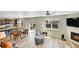 Open-concept living room with wood floors, fireplace, and seamless flow to kitchen and dining at 7888 E 139Th Pl, Brighton, CO 80602