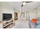 Carpeted sitting area features a television and bookshelves at 7888 E 139Th Pl, Brighton, CO 80602