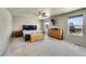 Spacious main bedroom with a ceiling fan, TV, and large windows offering plenty of natural light at 7888 E 139Th Pl, Brighton, CO 80602