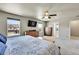 Comfortable main bedroom featuring bright natural light, ceiling fan, and neutral paint tones at 7888 E 139Th Pl, Brighton, CO 80602