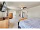 Open concept bedroom with ceiling fan and multiple doorways leading to other rooms at 7888 E 139Th Pl, Brighton, CO 80602