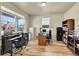 Functional home office with abundant natural light, spacious desks, shelving and wood floors, creating a productive workspace at 7888 E 139Th Pl, Brighton, CO 80602