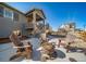 Backyard features a patio with a fire pit and chairs, ideal for outdoor entertaining at 1087 E Hopkins Dr, Elizabeth, CO 80107
