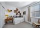 Cozy bedroom featuring a daybed with decorative pillows and a vintage desk with rustic shelving at 1087 E Hopkins Dr, Elizabeth, CO 80107