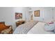 This bedroom features a white bed, a unique art collection, and wood accents at 1087 E Hopkins Dr, Elizabeth, CO 80107