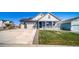 Beautiful home with a long driveway, attached garage, and covered front porch at 1087 E Hopkins Dr, Elizabeth, CO 80107