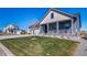 Inviting home with a well-manicured lawn and a welcoming front porch and attractive curb appeal at 1087 E Hopkins Dr, Elizabeth, CO 80107