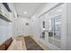 The hallway features a bench with storage and a gray runner on the wood floors at 1087 E Hopkins Dr, Elizabeth, CO 80107