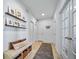 The hallway features a bench with storage and a gray runner on the wood floors at 1087 E Hopkins Dr, Elizabeth, CO 80107