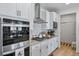 Bright kitchen featuring white cabinetry, stainless steel appliances, and granite countertops at 1087 E Hopkins Dr, Elizabeth, CO 80107