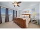 Comfortable main bedroom with a large bed, side tables, and windows at 1087 E Hopkins Dr, Elizabeth, CO 80107