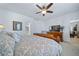 The main bedroom features a ceiling fan, television, and access to the ensuite bathroom and closet at 1087 E Hopkins Dr, Elizabeth, CO 80107