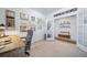 This carpeted office features an open doorway, a desk, a chair, and eclectic wall art at 1087 E Hopkins Dr, Elizabeth, CO 80107