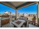 Covered patio with outdoor furniture, a fire pit, and a grill perfect for relaxing and entertaining at 1087 E Hopkins Dr, Elizabeth, CO 80107