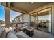 Relaxing covered patio with comfortable furniture, an inviting fire pit, and access to the interior at 1087 E Hopkins Dr, Elizabeth, CO 80107
