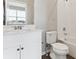 Bright bathroom with a white vanity, toilet, and tiled shower-tub combo at 6804 Merseyside Ln, Castle Pines, CO 80108