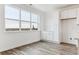 Dining area with hardwood floor and a large window that provides beautiful natural light. Additional storage to the right of the window at 6804 Merseyside Ln, Castle Pines, CO 80108