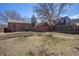 Spacious backyard featuring a detached garage and mature trees at 1235 S Josephine St, Denver, CO 80210