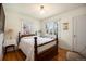 Comfortable bedroom features a wood bedframe, hardwood floors and bright, natural light at 1235 S Josephine St, Denver, CO 80210