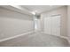 View of carpeted basement with sliding closet doors, neutral gray walls, and white trim, providing a clean aesthetic at 5905 S Platte Canyon Dr, Littleton, CO 80123