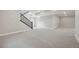 View of carpeted basement with staircase, neutral gray walls, and white trim, providing a clean and modern aesthetic at 5905 S Platte Canyon Dr, Littleton, CO 80123