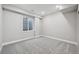 View of carpeted basement with window, neutral gray walls, and white trim, providing a clean aesthetic at 5905 S Platte Canyon Dr, Littleton, CO 80123