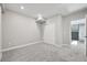 View of carpeted basement with sliding closet doors and staircase, neutral gray walls, and white trim at 5905 S Platte Canyon Dr, Littleton, CO 80123