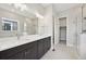 Stylish bathroom featuring a soaking tub, glass enclosed shower, and double vanity sinks at 5905 S Platte Canyon Dr, Littleton, CO 80123