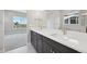 Modern bathroom featuring a double sink vanity with stone countertops and modern fixtures at 5905 S Platte Canyon Dr, Littleton, CO 80123