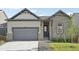 Charming home featuring a stone and siding facade, with a two-car garage and beautifully landscaped front yard at 5905 S Platte Canyon Dr, Littleton, CO 80123
