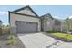 Beautifully landscaped home showcasing its stone and siding facade, two-car garage, and modern design at 5905 S Platte Canyon Dr, Littleton, CO 80123