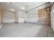 Spacious two car garage with high ceilings, finished walls, and concrete flooring at 5905 S Platte Canyon Dr, Littleton, CO 80123