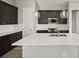 Stylish kitchen boasts an island with quartz countertop, stainless steel appliances, and ample storage at 5905 S Platte Canyon Dr, Littleton, CO 80123