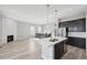 Open kitchen and living area with island, fireplace, and stainless steel appliances at 5905 S Platte Canyon Dr, Littleton, CO 80123