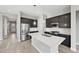 Modern kitchen featuring stainless steel appliances, an island with quartz countertop, and dark wood cabinets at 5905 S Platte Canyon Dr, Littleton, CO 80123