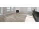 Bright living room features hardwood floors, large windows, and a modern fireplace at 5905 S Platte Canyon Dr, Littleton, CO 80123