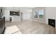 Open-concept living room showcasing hardwood floors, a fireplace, and seamless transition to the kitchen at 5905 S Platte Canyon Dr, Littleton, CO 80123