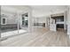 Expansive living area with hardwood floors, large windows, and an open layout connecting to the kitchen at 5905 S Platte Canyon Dr, Littleton, CO 80123