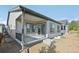 Exterior view of a covered patio adjacent to a gray home, offering an outdoor living space at 5905 S Platte Canyon Dr, Littleton, CO 80123