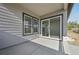 A covered patio with concrete flooring and sliding glass doors offers seamless indoor-outdoor living at 5905 S Platte Canyon Dr, Littleton, CO 80123
