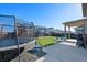 Beautiful backyard featuring a trampoline, patio, and grassy area perfect for outdoor activities and Gathering fun at 26909 E Cedar Ave, Aurora, CO 80018