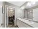 Modern bathroom featuring double sinks, a large mirror, and an adjacent shower, creating a practical space at 26909 E Cedar Ave, Aurora, CO 80018
